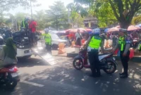 Petugas kepolisian lalu lintas melakukan pemeriksaan kendaraan dalam sebuah operasi di jalan raya.( Poto : pariwarajambi.com )