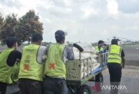 Petugas melakukan pemindahan garam menuju pesawat di posko subsatgas udara karhutla Bandara SultanThaha Jambi. ( poto : ANTARA)