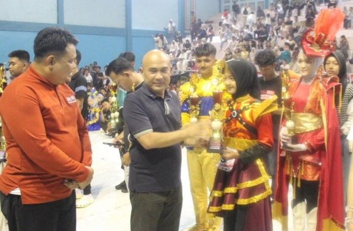 Bupati Bungo menyerahkan trofi kepada Tim Marching Band Bahana Syahdu MTsN 7 Bungo.(poto: jambiprima.com).