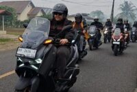 Bupati M. Syukur memimpin langsung rombongan pejabat daerah menembus jalan raya menuju pelosok desa dengan mengendarai skuter matik bongsor Yamaha X-Max.(poto: kominfo).